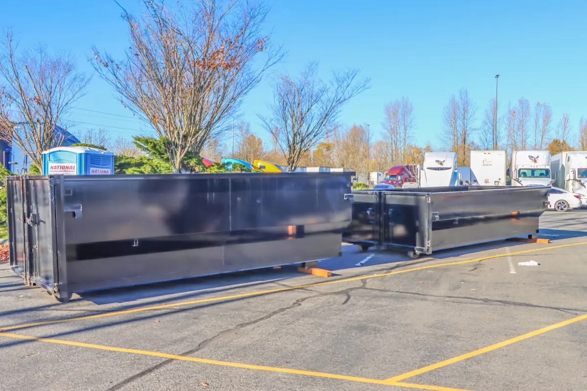 Professional dumpster rental service with roll-off container on residential driveway in Elmhurst
